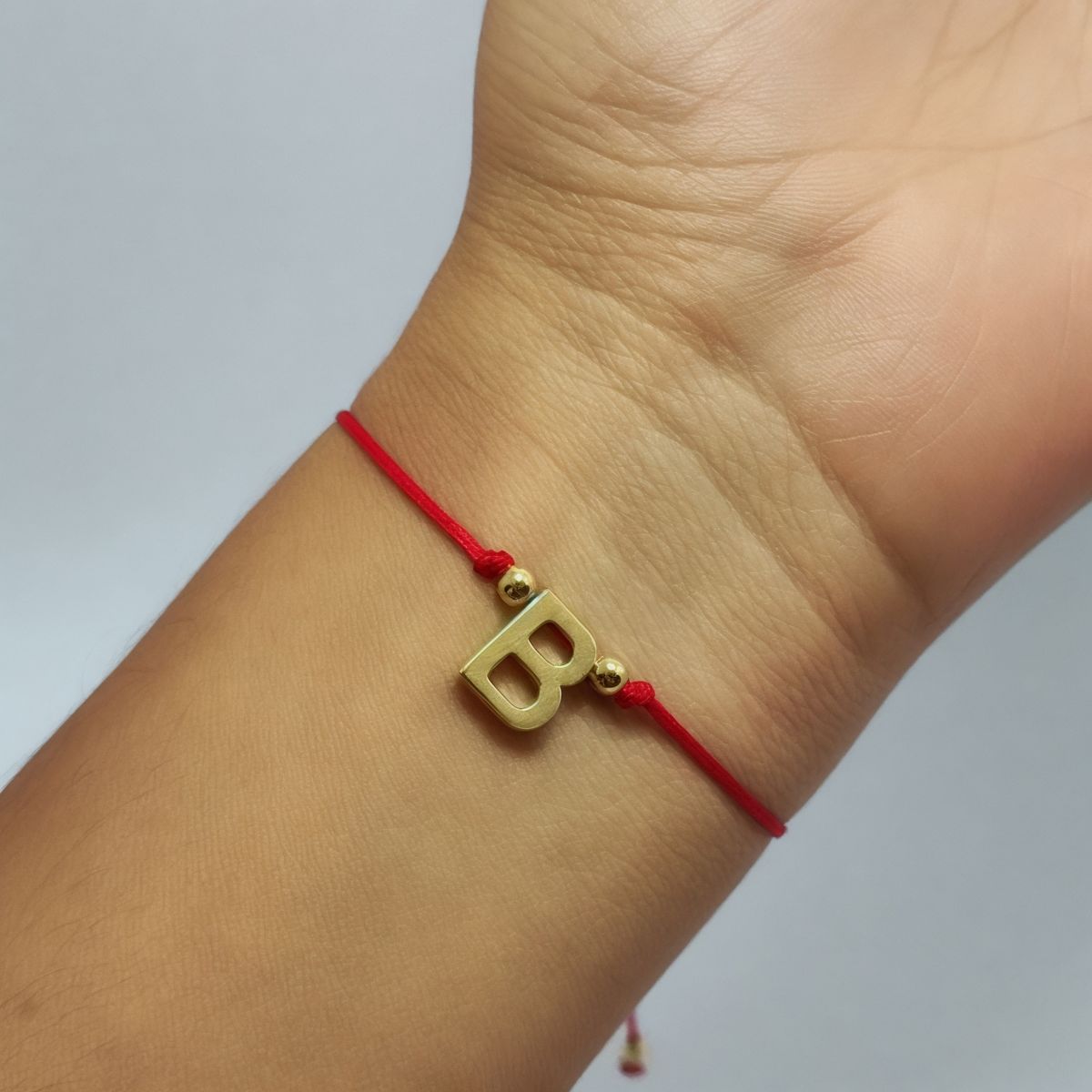 ANDREA COGGIOLA JOYAS - Pulsera Letra B Cordón Rojo Enchapado Oro 18K