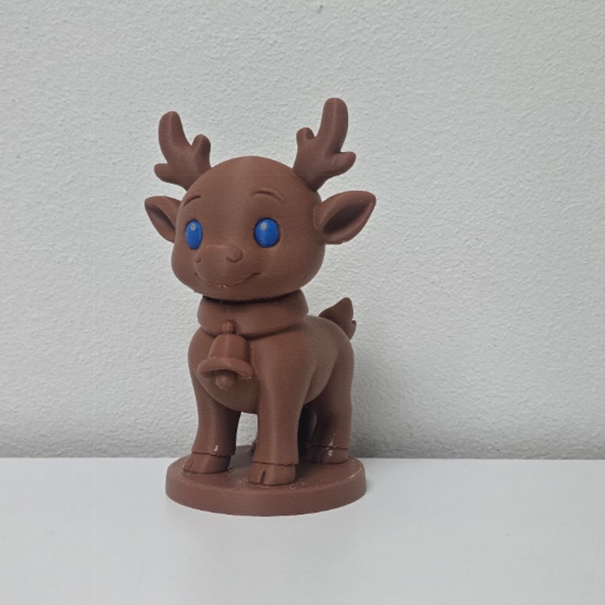 GENERICO - Reno con ojos azules y figura navideña de campana