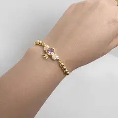 GENERICO - PULSERA DORADA AJUSTABLE DISEÑO DE CORAZON ROSADO CON ALAS BAÑO DE ORO