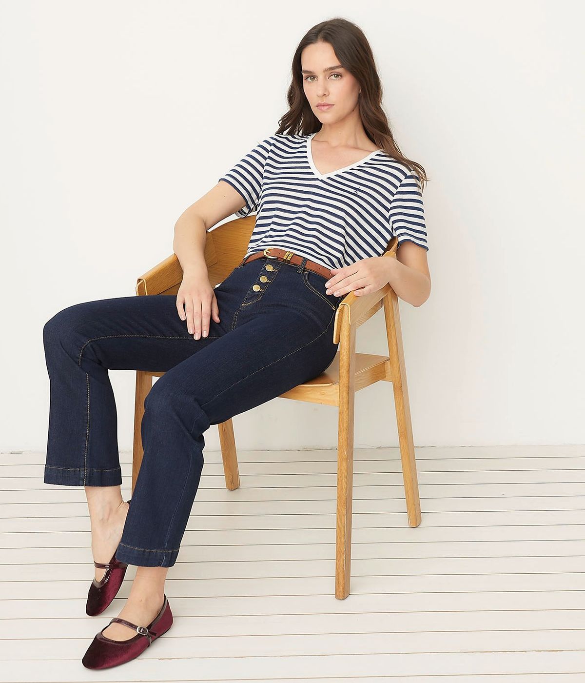 Cropped dark-blue flare jeans worn with a striped tee and burgundy Mary Jane flats