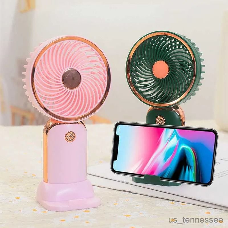 GENERICO - VENTILADOR MINI  DE MANO RECARGABLE SOPORTE BASE A CELULAR COLORES