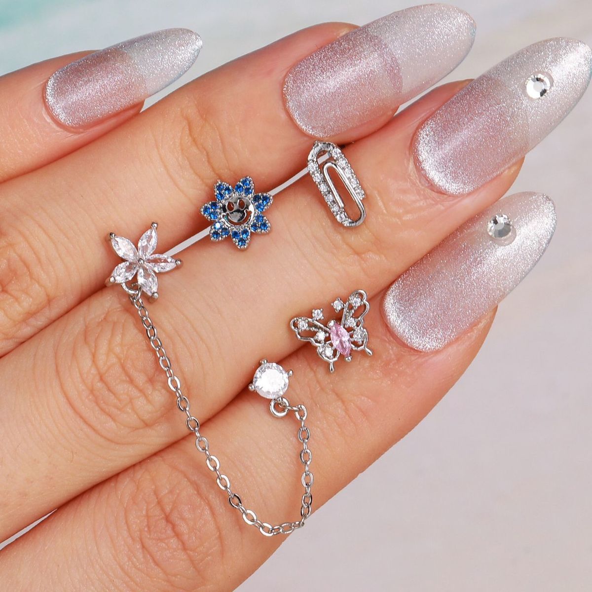 CLEO JOYAS & ACCESORIOS - Piercing Doble Flor Luz Plateado Acero