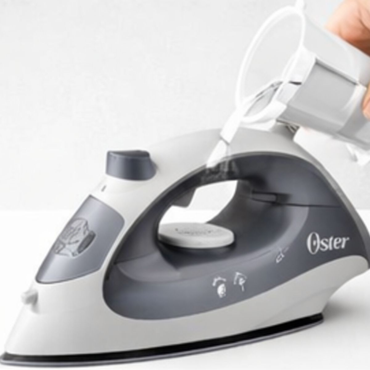 OSTER - Plancha de Vapor Oster 1400W Compacta Antiadherente Ligera Ropa Impecable GCSTBS5001